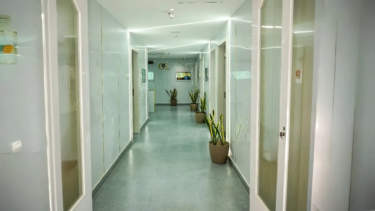 Sleek clinic corridor leading to the billing bay and specialist consultation rooms