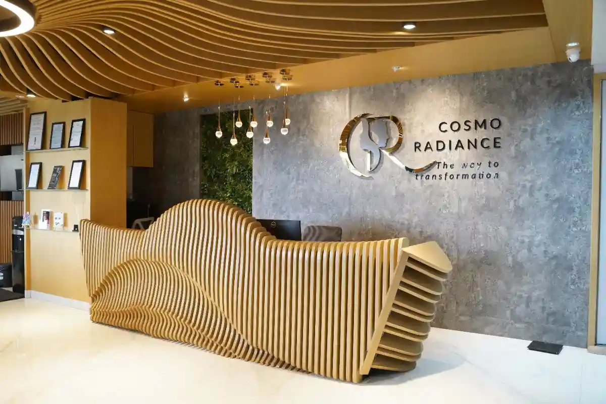 Close-up of the intricate parametric wooden ceiling design and warm lighting above the reception