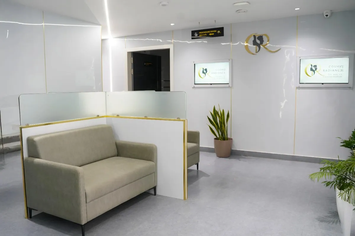 Patient waiting lounge featuring comfortable seating and LCD screens for educational videos