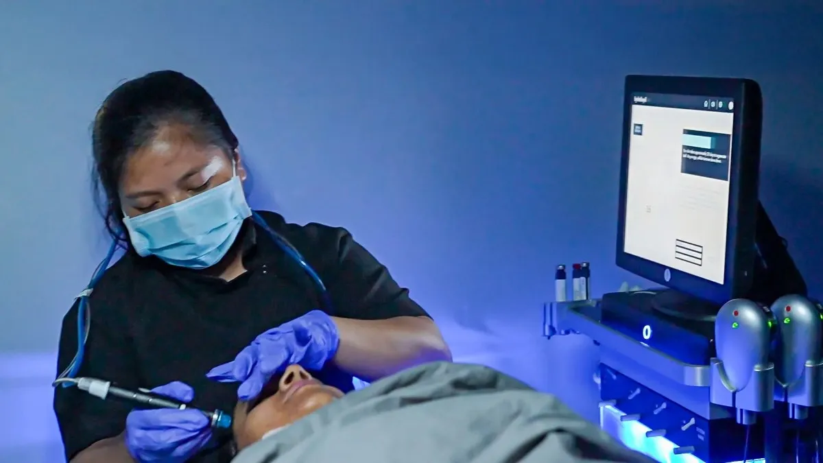 Medical staff performing a Hydrafacial Elite procedure under the guidance of a dermatologist