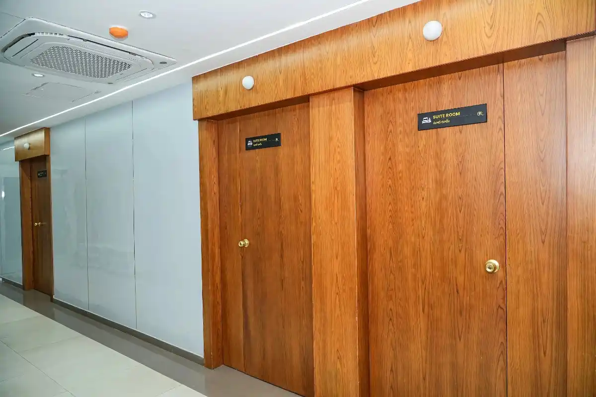 Quiet corridor with wooden doors leading to the private inpatient suite wing