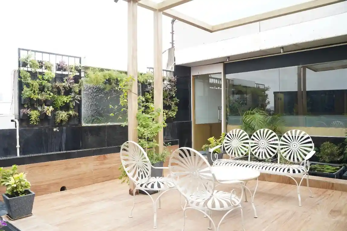 Tranquil outdoor terrace lounge with a mirror water wall and vertical garden